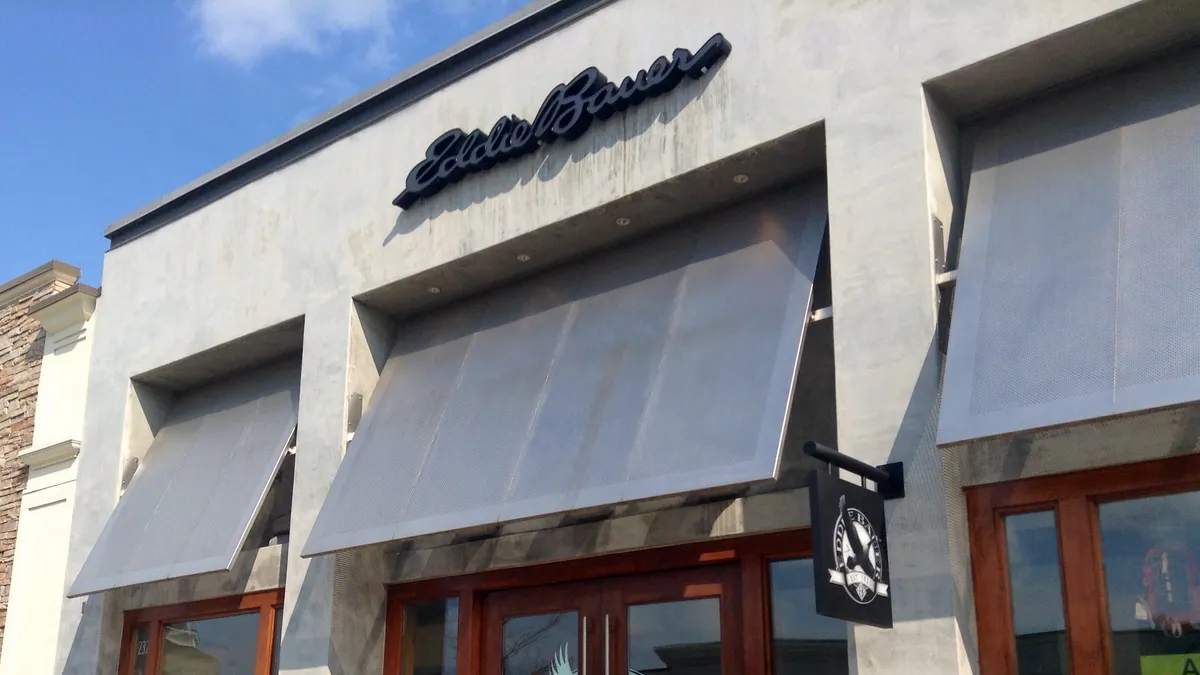 A storefront with awnings and bright blue skies above.