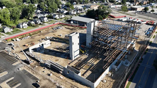 A shot from above of an under-construction building with its frame and foundation exposed.