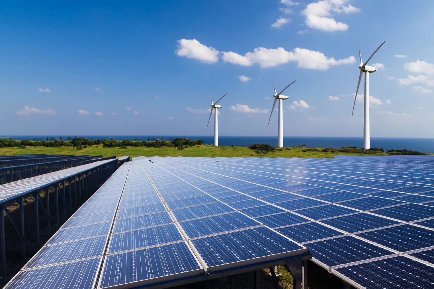 Solar panels and wind turbines in a field