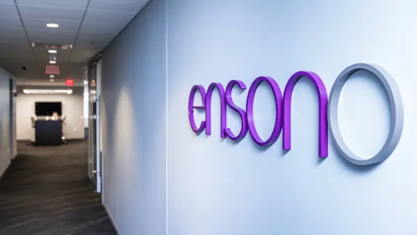 A hallway in an office building with the Ensono company logo pictured on the way.