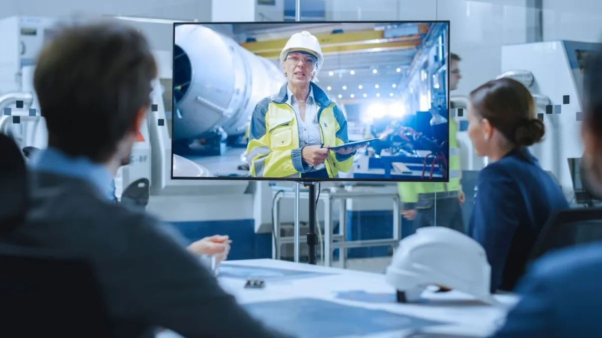 Diverse Group of Specialists, Managers in the Factory Office Meeting Room, Have Conference Video Call with Factory Chief Female Engineer