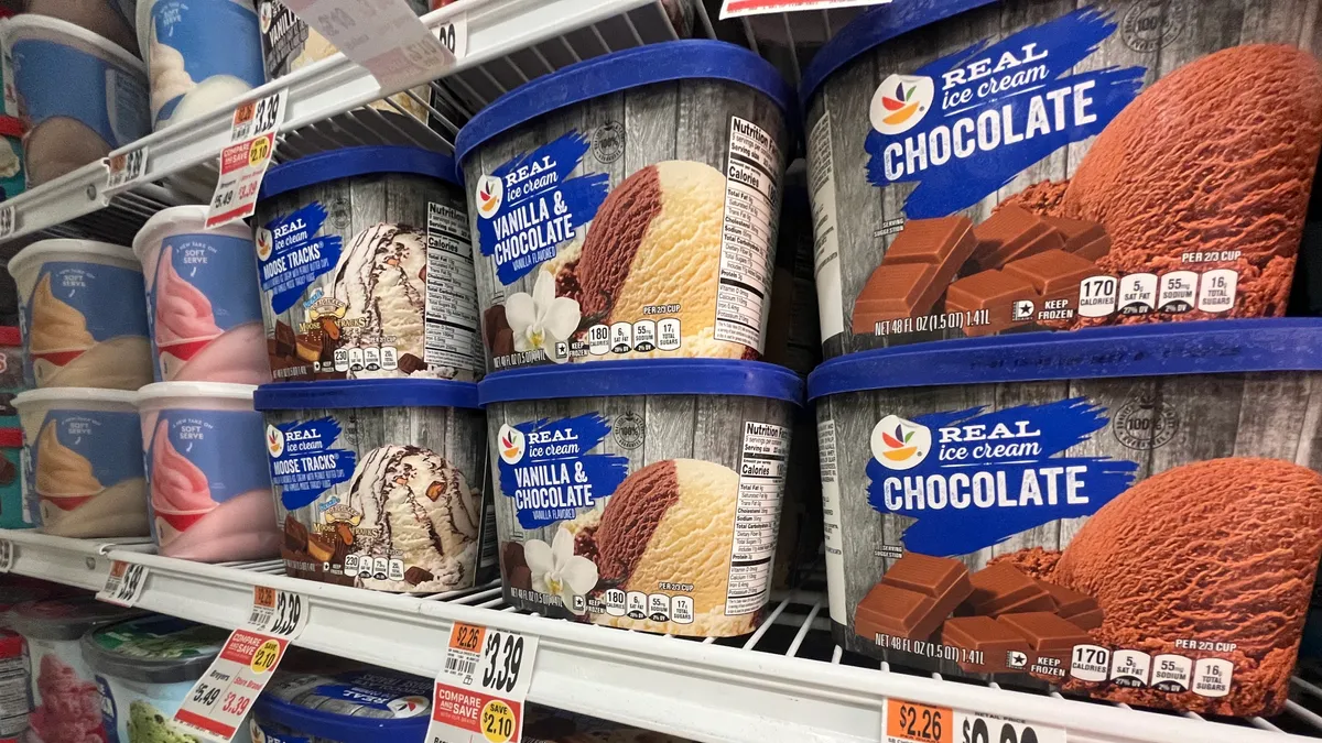 Close up of ice cream containers in freezers.