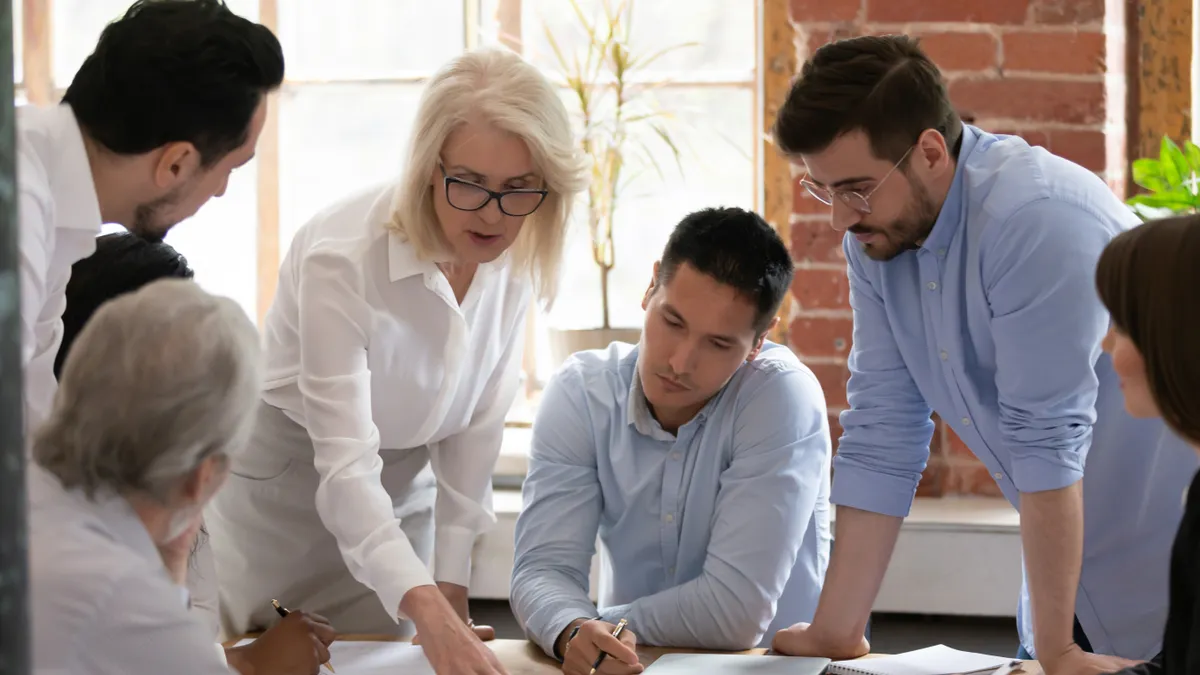 A team of multiethnic lawyers discuss a project for a client