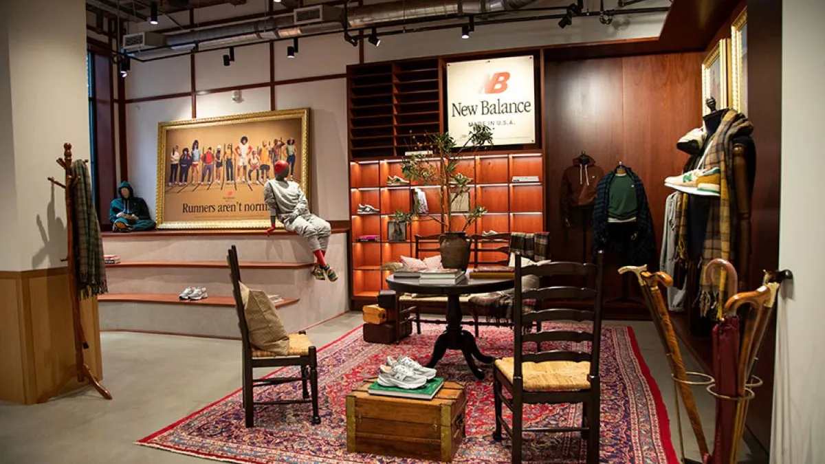 Interior shot of a New Balance retail concept in store in Boston, with wicker chairs, a rug, and