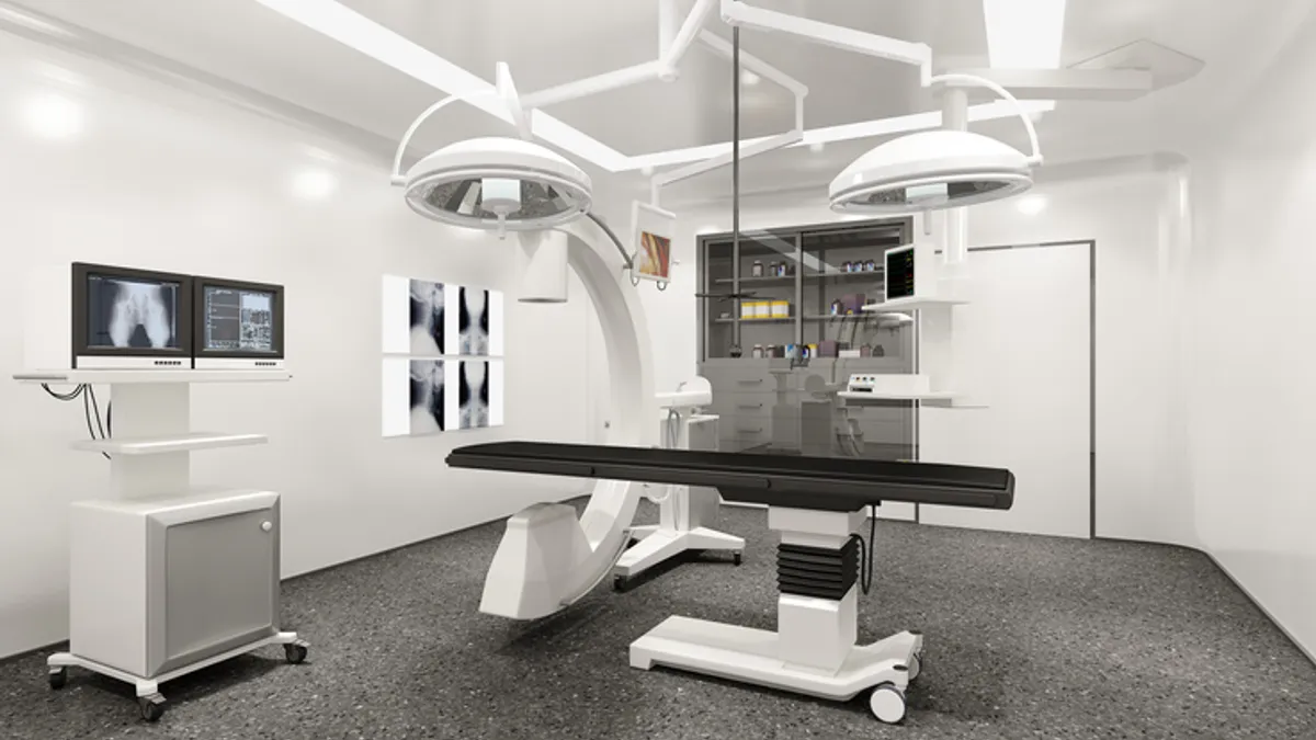 A C-arm system is used for imaging in this rendering.