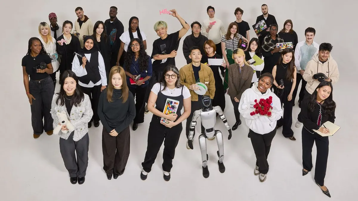 Dozens of Hex employees and a robot stand on a beige-colored floor