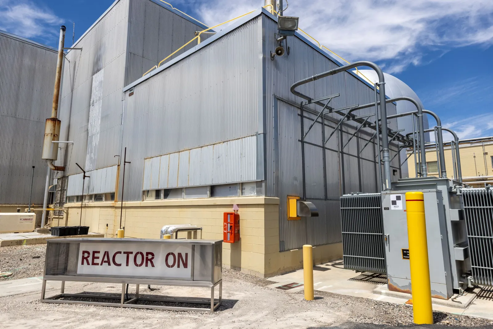 A sign outside an industrial facility that says "reactor on."