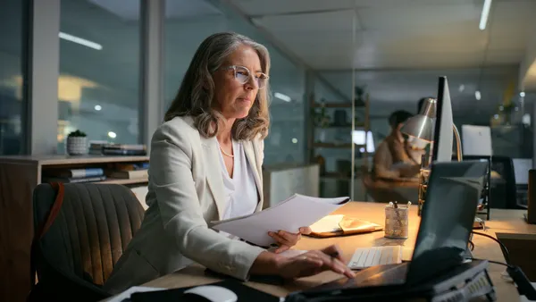 Woman, night and laptop for financial email to client
