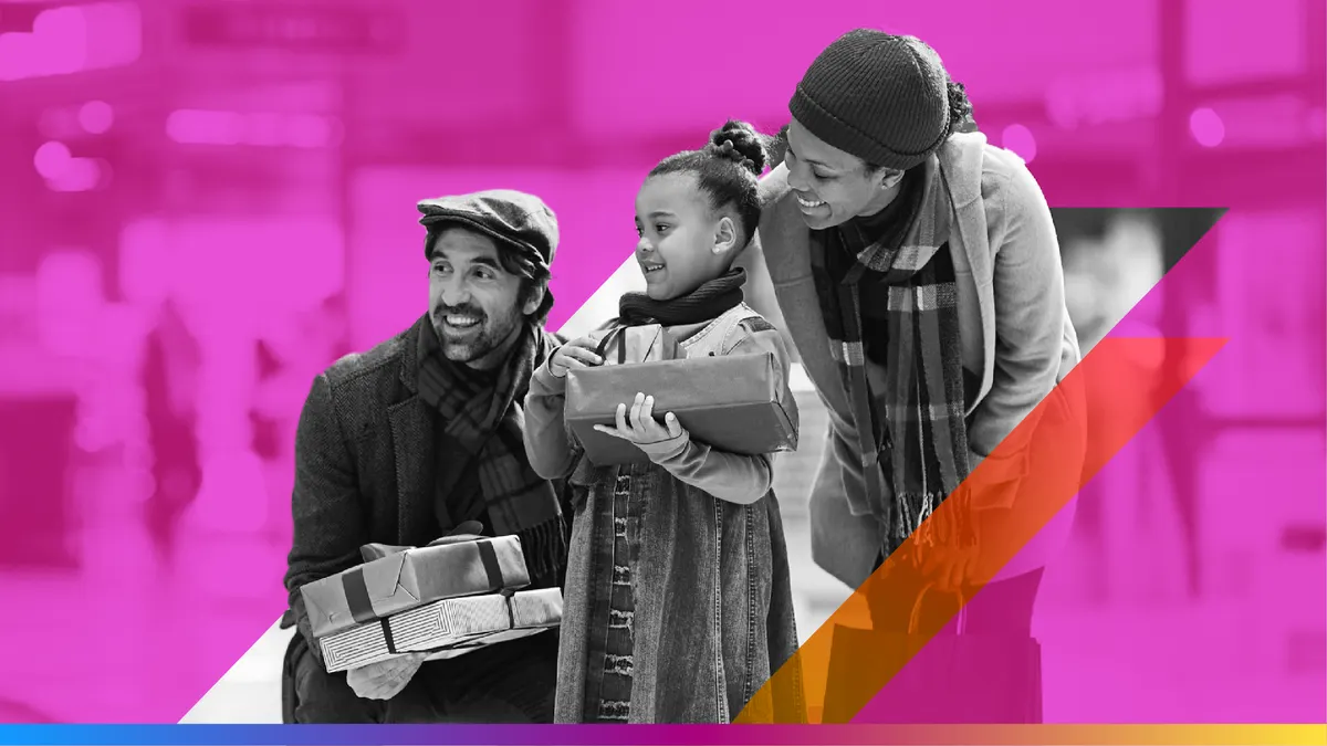 Two adults with a kid holding presents