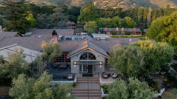 The exterior of the hotel with mountains in the background.