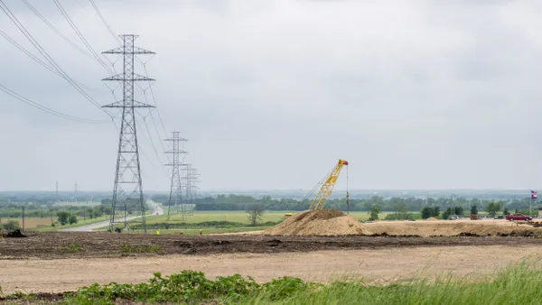 Transmission towers run alongside a road