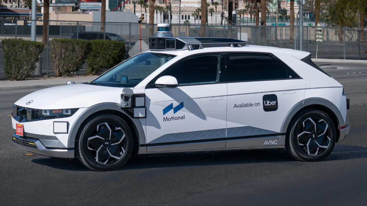 A Hyundai Ioniq 5 robotaxi operated by Motional and Uber on a road in Las Vegas.