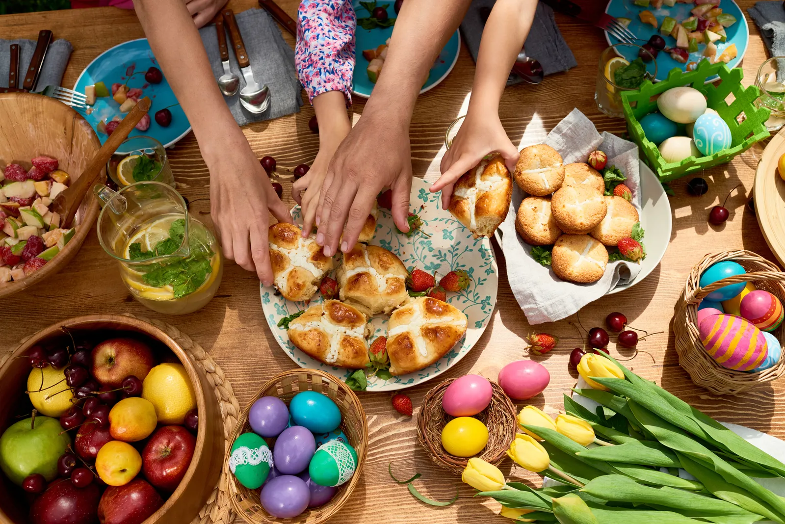 View of family taking sweet buns during Easter dinner.