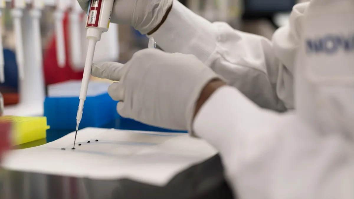 An employee of Novavax works on development of a coronavirus vaccine