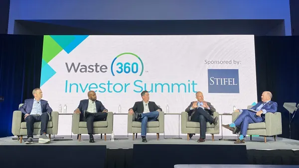 Five people sit on a stage with a digital screen reading "Waste 360 Investor Summit, Sponsored by Stifel" behind them.
