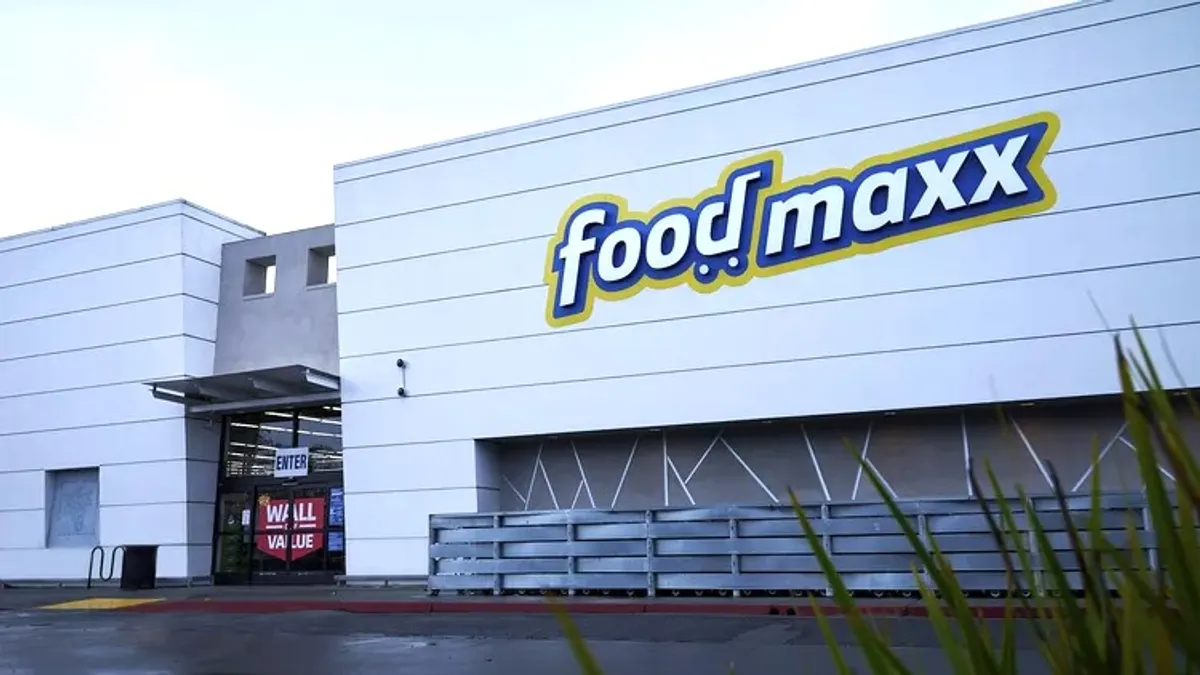 Exterior of a light gray building with a sign that reads "FoodMaxx."