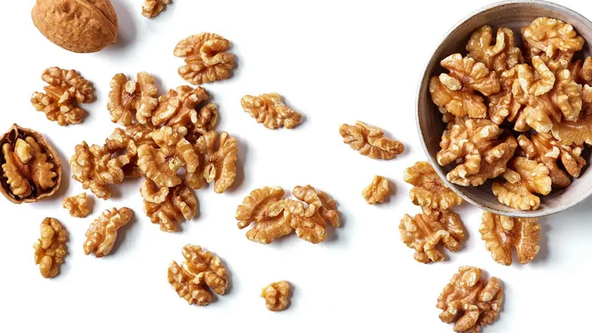 Picture of walnuts across a white table