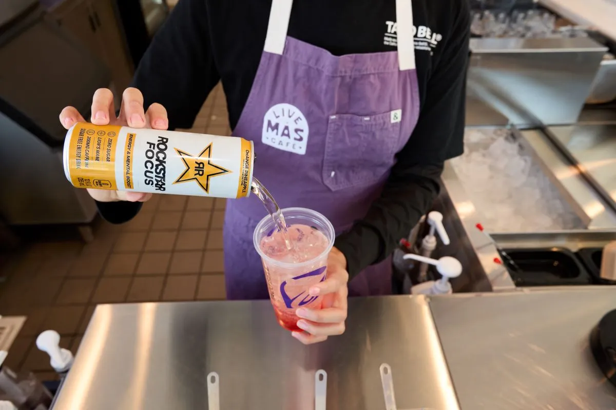 A Taco Bell worker prepares a drink at Taco Bell&#x27;s Live Mas Cafe