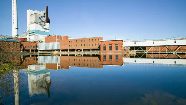 A wide shot of an industrial facility alongside a body of water.