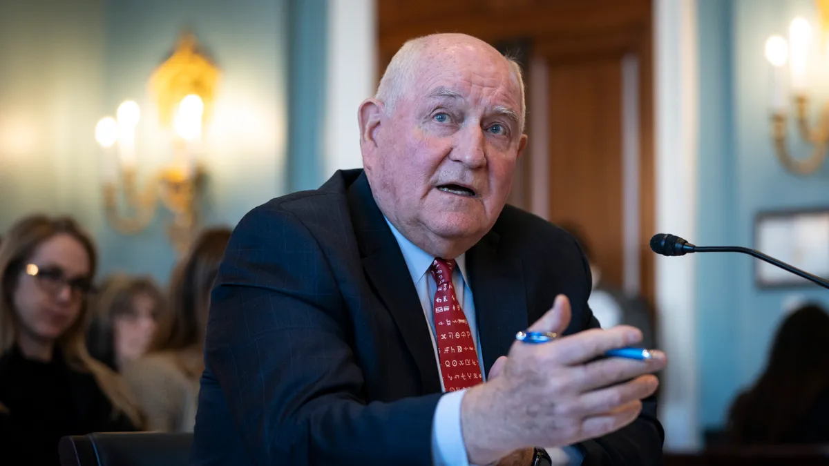 USG Chancellor Sonny Perdue speaks at a table.