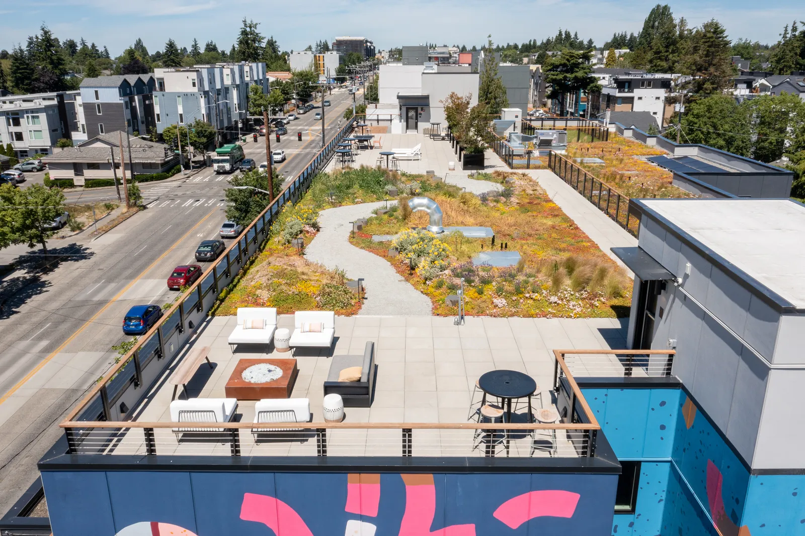 A building roof with a green space and chairs.