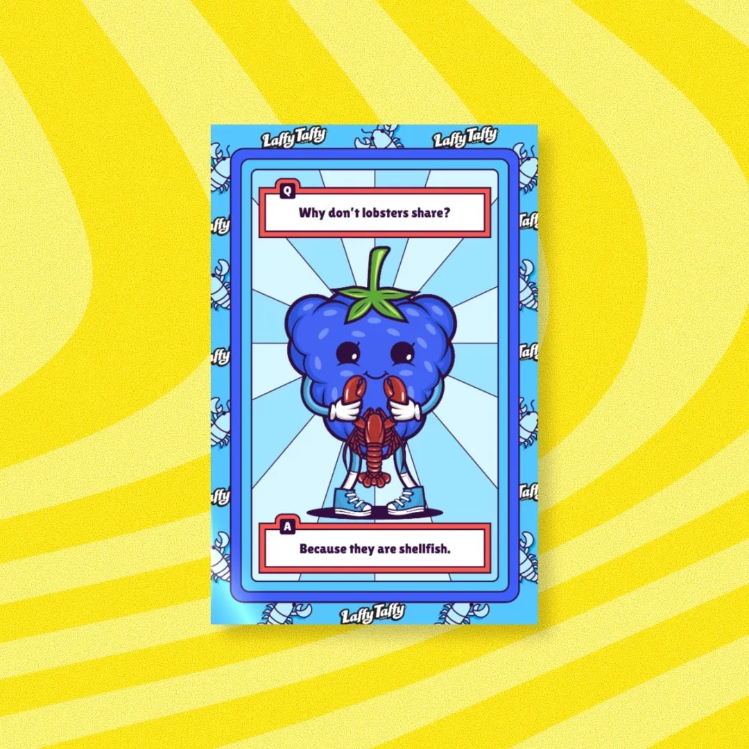 A cartoonish blue raspberry with a smile holds a lobster on a Laffy Taffy card.