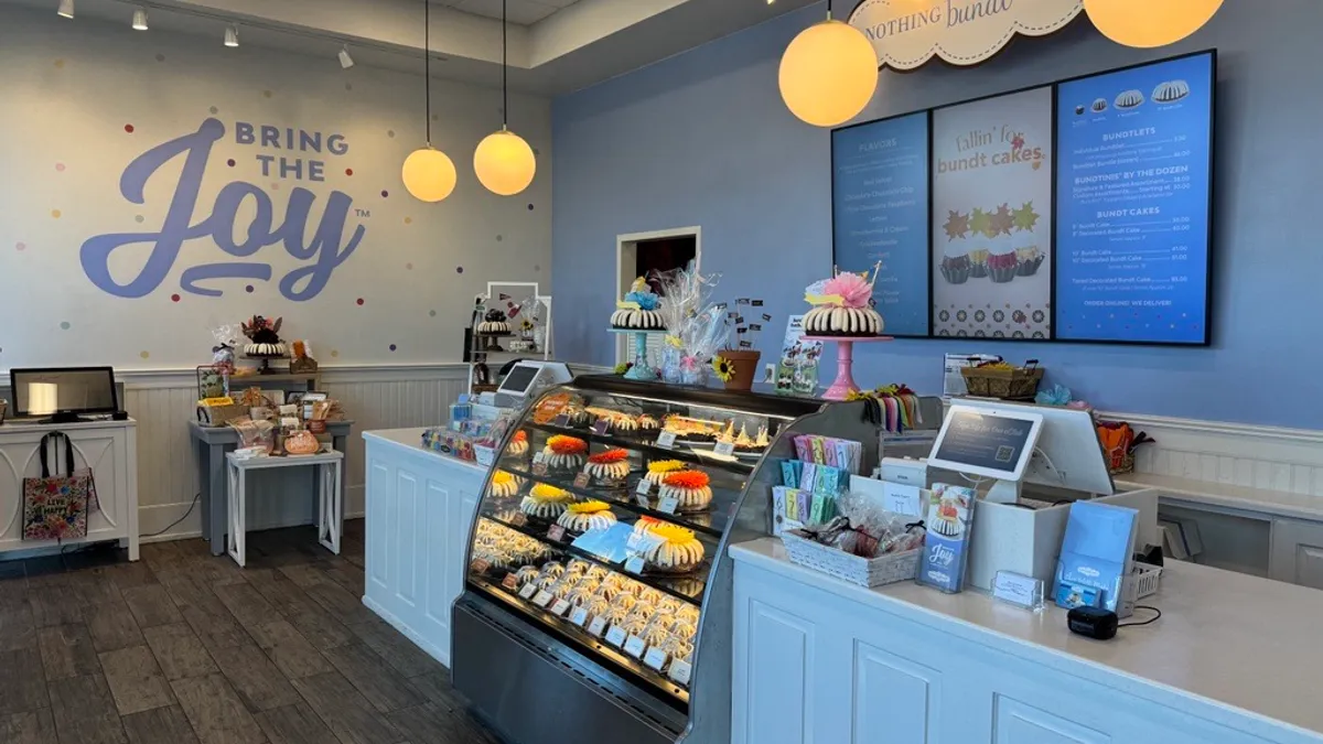 An image of a front counter with bundt cakes in the display case