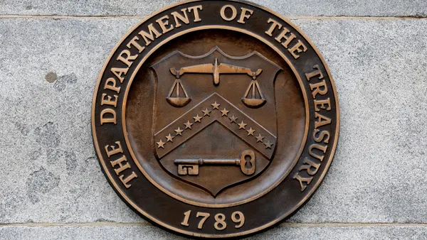 The brown-and-gold seal of the Treasury Department is seen on the wall of its headquarters building
