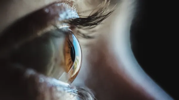 A close-up of a person's brown eye.