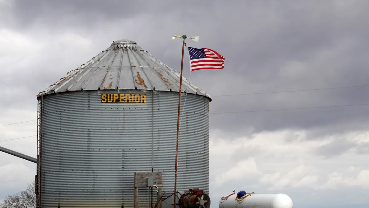 The U.S. flag is seen in front of a grain silo