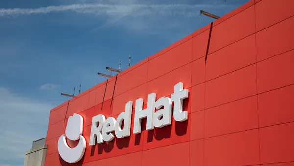 A red building with a hat icon and the words "Red Hat" in white on the side