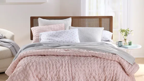 A bed with products from Macy's Arch Studio private label