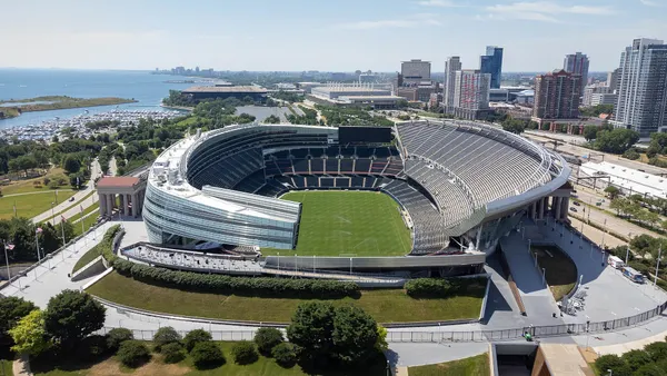 A shot of a stadium in the direct sunlight. The stadium is empty, and no game is taking place.