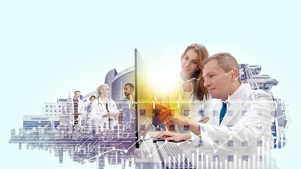 Medical professionals talking and looking at a desktop computer