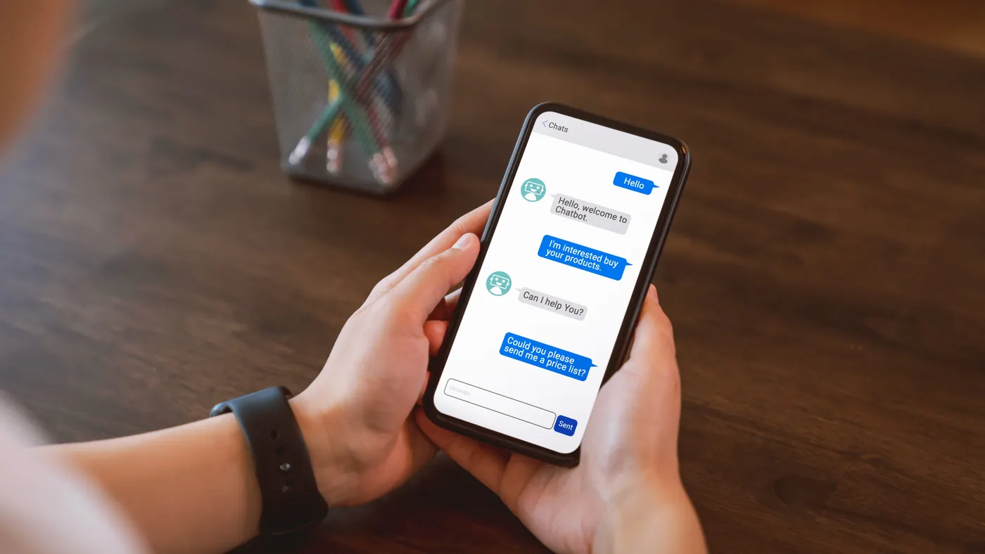 A person talks to a chatbot on their phone