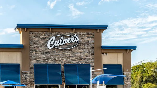 A photograph of a beige brick building with a sign that says Culver's