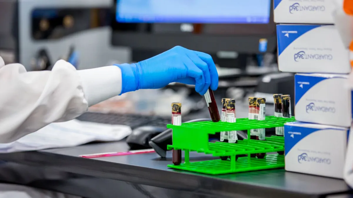 a lab worker with testubes of blood