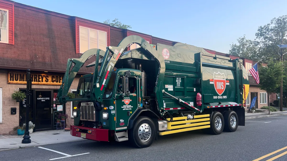 An Interstate Waste Services truck in front of a business