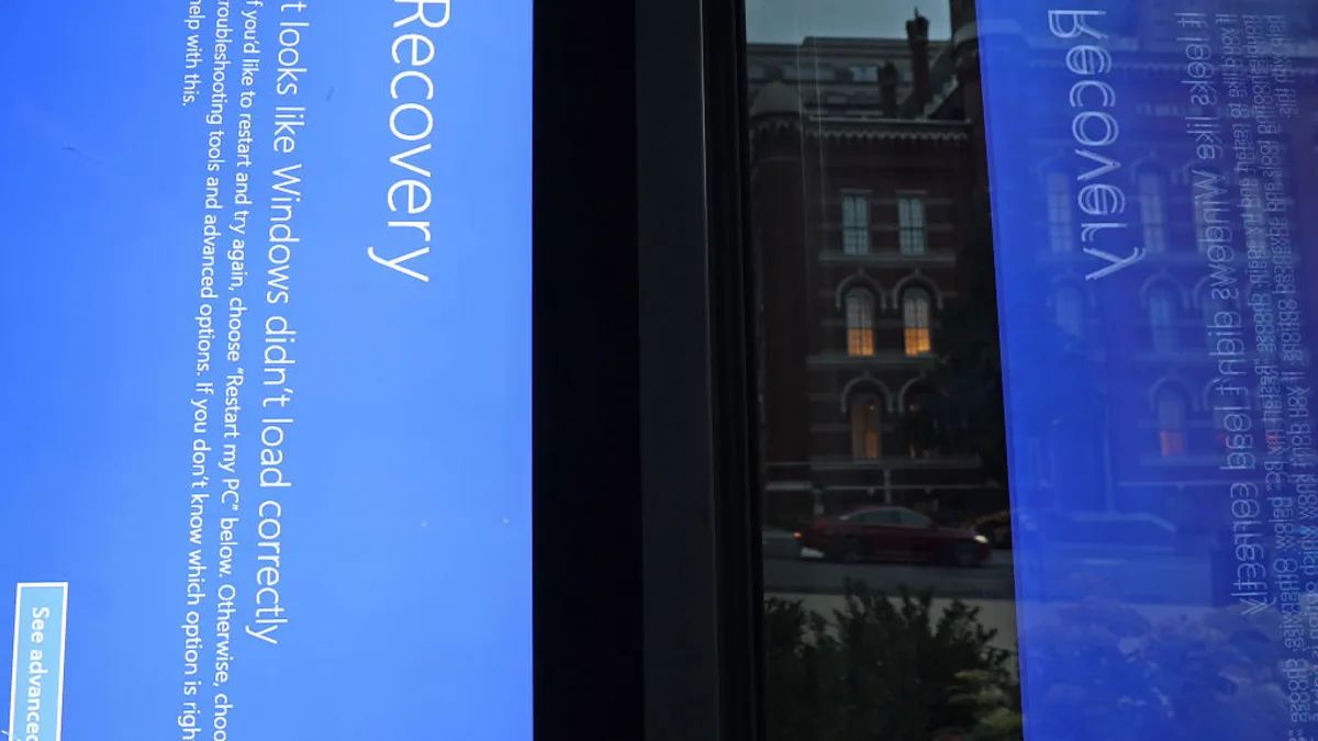 A blue Windows error message caused by the CrowdStrike software update is displayed on a screen in a bus shelter on July 22, 2024 in Washington, DC. Four days after CrowdStrike issued a faulty software upgrade that impacted an estimated 8.5 million Microsoft devices around the world.