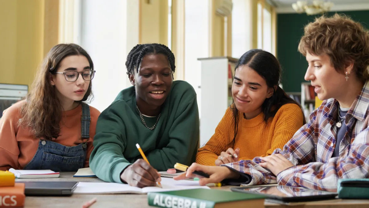 A group of students collaborating on a project at a table.