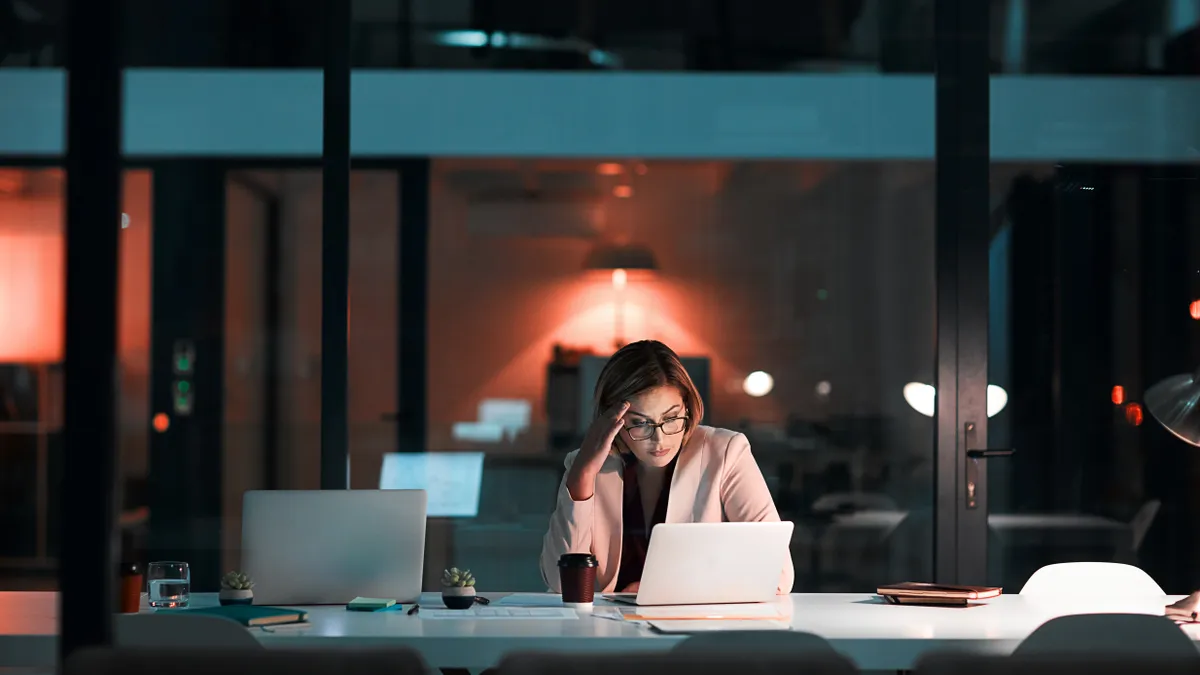 Shot of a businesswoman feeling worn out during a late night at work