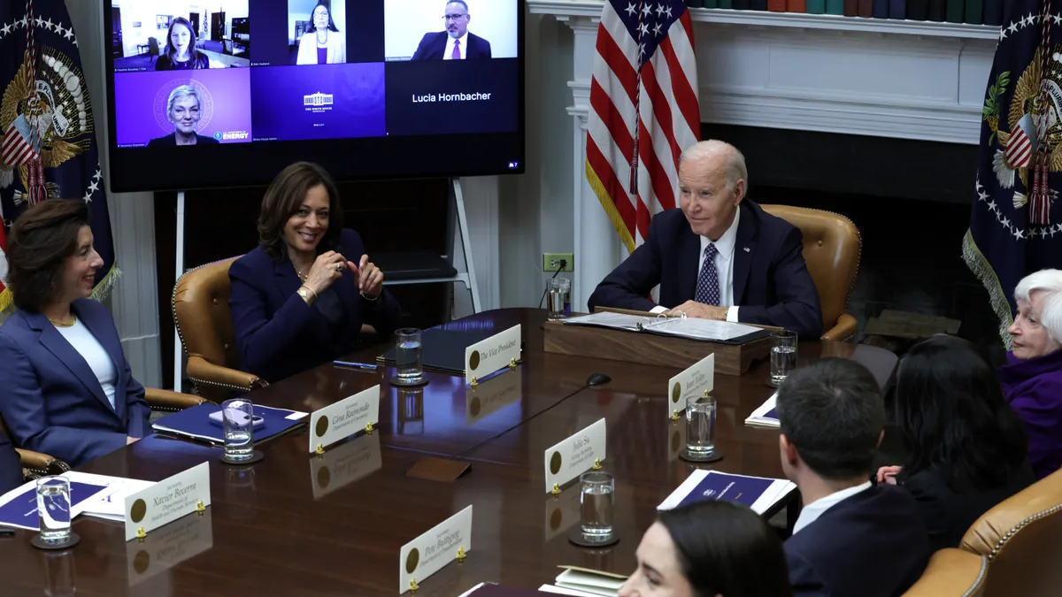 President Joe Biden speaks as (L-4th L) Secretary of Commerce Gina Raimondo, Vice President Kamala Harris and Secretary of the Treasury Janet Yellen listen during a meeting with his Investing in Ameri