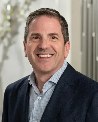 Headshot of a man in a suit.