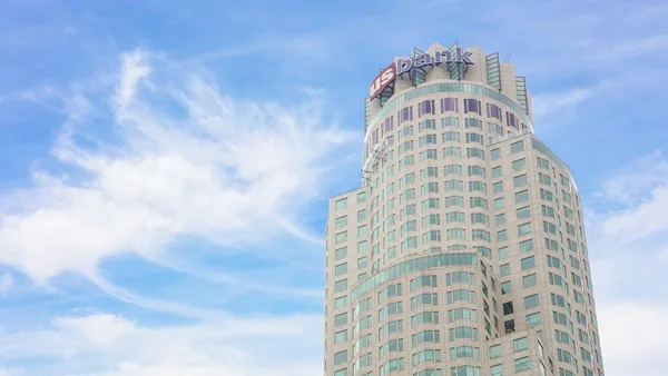 A skyscraper with the name "U.S. Bank" atop it is shown.