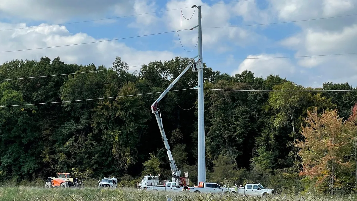 Utility crews work on a transmission line.