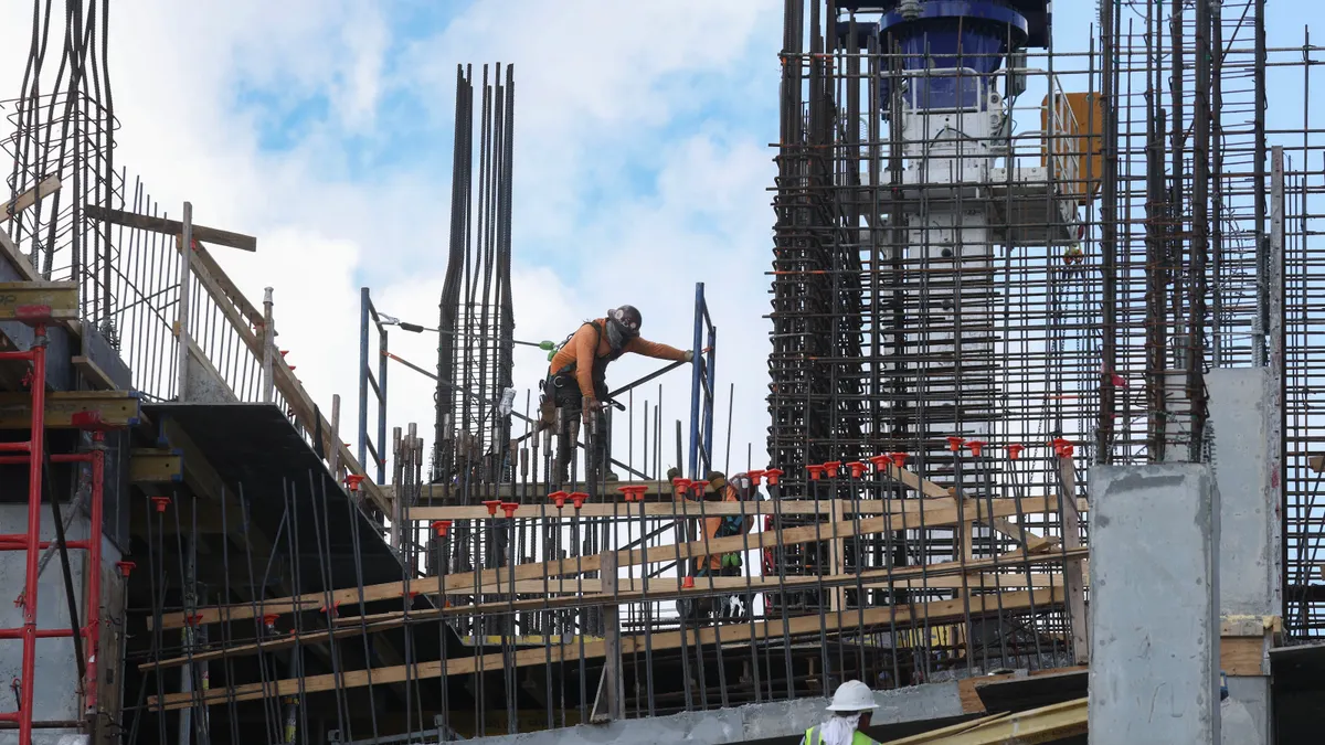 Construction workers using steel rebar