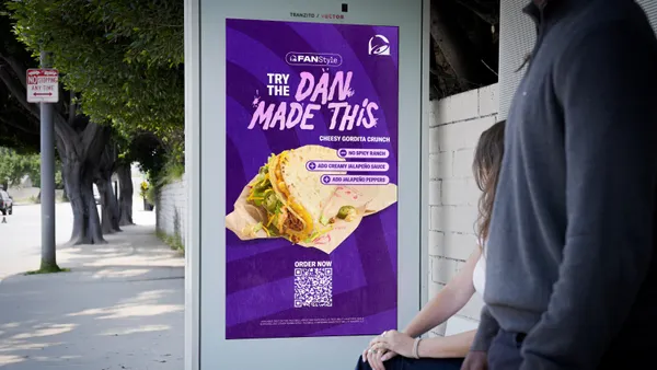 A personalized Taco Bell advertisement at a bus stop.