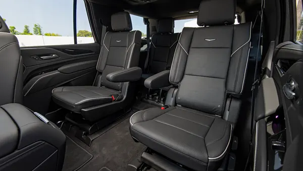 The second-row seats in a 2021 Cadillac Escalade, covered in black leather.