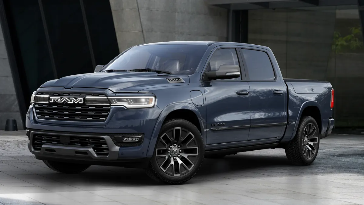 The 2026 Ram 1500 REV Tungsten parked in front of concrete wall,