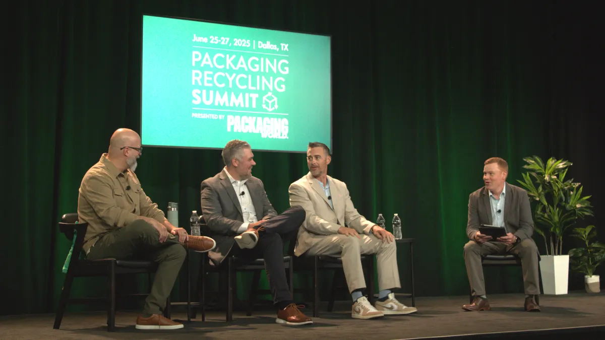 Four people sit in chairs on a stage in front of a green background that says Packaging Recycling Summit.